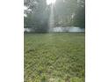 A spacious, sun-drenched backyard with lush green grass and a pristine white fence offering privacy at 233 N Pandora Dr, Goose Creek, SC 29445