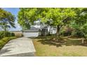 Picturesque home surrounded by lush greenery with a long driveway and a spacious two-car garage at 2345 Waring Hall Ln, Charleston, SC 29414