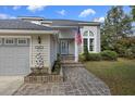 Inviting front entrance with brick walkway, American flag, and well-maintained landscaping at 2345 Waring Hall Ln, Charleston, SC 29414