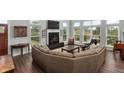 Open-concept living area featuring a fireplace, large windows, and comfortable seating at 2480 Royal Oak Dr, Johns Island, SC 29455