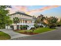 Inviting two-story coastal home with a spacious front porch and landscaped yard, creating a welcoming curb appeal at 2504 Ballast Pt, Mount Pleasant, SC 29466