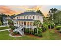 Stately two-story home featuring a classic design with a covered porch and mature landscaping for enhanced privacy at 2504 Ballast Pt, Mount Pleasant, SC 29466