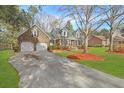 Attractive brick home shows a two-car garage, green roof, and well-landscaped yard with mulch at 305 Mayfield St, Summerville, SC 29485