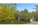 Aerial view of a brick home with lush green lawn, mature trees and a long driveway at 3176 Hagerty Dr, Charleston, SC 29414