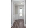 Bright entryway featuring wood-look floors and white wainscoting, creating a welcoming and stylish entrance at 334 Dahlia Row Dr, Summerville, SC 29486