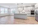Spacious kitchen featuring a large island, modern appliances, and lots of natural light at 355 Wappoo Trace Ln, Summerville, SC 29486