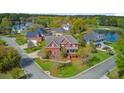 Aerial view of a two-story brick home with a well-manicured lawn and lush greenery at 3584 Somerset Hills Ct, Mount Pleasant, SC 29466
