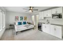 Bright bedroom featuring modern decor with kitchenette, ceiling fan, and a comfortable bed with stylish accents at 4060 S Rhett Ave, North Charleston, SC 29405
