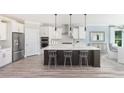 Modern kitchen featuring an island with seating, stainless steel appliances, and sleek cabinetry with ample counter space at 5104 Coneflower Ct, Johns Island, SC 29455