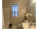 Cozy bathroom featuring a tub, tile flooring, vanity, and a window with decorative curtain at 5182 Forest Oaks Dr, Hollywood, SC 29449
