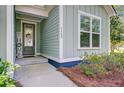 Close up view of a charming and inviting front entrance of a single-Gathering home at 5560 Alpine Dr, Summerville, SC 29483