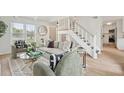Chic living room features stylish seating, a staircase, and wood flooring at 5573 Betty Ct, North Charleston, SC 29418
