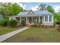 Charming single-story home with a metal roof, a covered front porch and landscaped front yard at 617 Hampton St, Walterboro, SC 29488