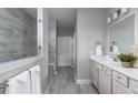 Bright bathroom with walk-in shower, dual vanity, and neutral tile at 630 Coral Bells Ln, Summerville, SC 29486