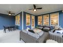 Covered outdoor patio with seating, ceiling fans, and blue siding at 630 Coral Bells Ln, Summerville, SC 29486