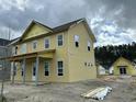 Side view of a charming two-story home under construction, featuring multiple windows and a covered porch at 715 Blueway Ave, Summerville, SC 29486