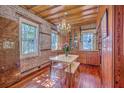 Bright dining area with hardwood floors, chandelier, and rustic wood paneling, perfect for intimate gatherings at 73 Anson St, Charleston, SC 29401