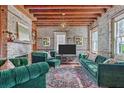 Cozy living room features exposed brick walls, wood beam ceiling, fireplace, and a stylish area rug at 73 Anson St, Charleston, SC 29401