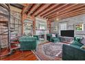 Inviting living room with spiral staircase, exposed brick, and wood beam ceiling, creating a unique and stylish space at 73 Anson St, Charleston, SC 29401