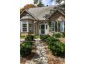 Close up of welcoming front entrance with stone path and lush landscaping at 956 Provincial Cir, Mount Pleasant, SC 29464