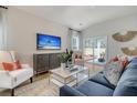 Comfortable living room with a plush blue sofa, decorative accents, and light wood flooring at Tbd O'Leary Circle, Summerville, SC 29483