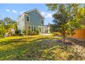 Expansive backyard featuring a screened-in porch and a well-maintained lawn at 1213 Captain Rivers Dr, Charleston, SC 29412