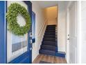 Inviting entryway featuring a blue door, wreath, and staircase to the upper level at 1213 Gatch Ct, Mount Pleasant, SC 29464
