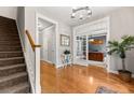 Spacious foyer featuring hardwood floors, a staircase, and an open view to an office through glass doors at 135 Marshside Dr, Summerville, SC 29485