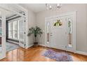Bright foyer with hardwood floors, a decorative rug, and a white front door with sidelights and transom windows at 135 Marshside Dr, Summerville, SC 29485
