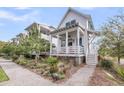 Beautiful exterior view showcasing a home with a porch and a lush landscaped yard at 1466 Mizzen Aly, Johns Island, SC 29455
