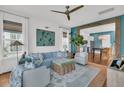 Cozy living room featuring a blue sofa, stylish decor, and an open layout to the kitchen at 1466 Mizzen Aly, Johns Island, SC 29455