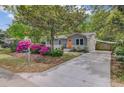 Charming home with light-gray siding, white brick, orange door, and beautiful azaleas in a well-maintained front yard at 1531 Seacroft Rd, James Island, SC 29412