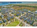 Aerial view showcases a well-planned neighborhood with a park, pond, and proximity to the water at 1555 Willtown St, Daniel Island, SC 29492
