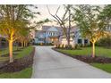 Inviting two-story home with manicured lawn and a private driveway leading to a spacious two-car garage at 1857 W Canning Dr, Mount Pleasant, SC 29466
