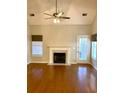 Bright living room showcasing a fireplace with white mantle, fan and lighting, and glossy hardwood flooring at 2000 Gray Battery Court Ct, Mount Pleasant, SC 29464