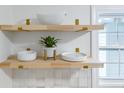 Bright kitchen featuring open shelving, white dishware, and a decorative potted plant at 201 Driver Ave, Summerville, SC 29483