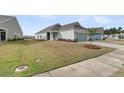 Quaint one-story home featuring manicured lawn, driveway, and beautiful exterior at 202 Garden Gate Way, Summerville, SC 29486