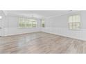 Bright living room with multiple windows, white trim and neutral walls and flooring at 215 Overcup Loop, Summerville, SC 29486
