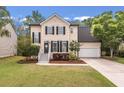 Charming two-story home with manicured lawn, tidy landscaping, black shutters and a welcoming front porch at 2226 Red Fern Lane, Mount Pleasant, SC 29466