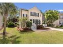 Two story home with mature trees, manicured lawn and landscaping, and a welcoming front porch at 2226 Red Fern Lane, Mount Pleasant, SC 29466