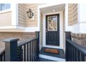Inviting front door with sidelight, lantern, and brick accents enhancing curb appeal at 2519 Rutherford Way, Charleston, SC 29414