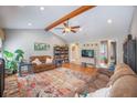 A cozy living room featuring laminate flooring, a vaulted ceiling, comfortable furniture, and charming decor at 306 Teakwood Dr, Walterboro, SC 29488