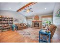 Inviting living room featuring hardwood floors, vaulted ceiling, fireplace, and ample natural light at 306 Teakwood Dr, Walterboro, SC 29488