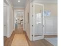 Inviting hallway featuring hardwood floors and stylish decor, leading to other rooms at 4155 Jean Laffite Rd, Hollywood, SC 29449