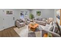 Bright living room featuring hardwood floors, neutral paint, and comfortable seating with a view of the outdoors at 4412 Abby Dr, North Charleston, SC 29418