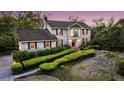Charming two-story traditional home featuring a lush landscaped front yard with mature trees and manicured hedges at 506 Fairington Dr, Summerville, SC 29485