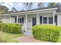 Inviting front porch with classic railings and meticulously maintained landscaping at 509 Hill St, Moncks Corner, SC 29461