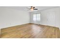 Bright living room featuring sleek wood floors, fresh paint, and a door at 509 Hill St, Moncks Corner, SC 29461
