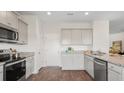 Well-equipped kitchen with granite countertops, stainless steel appliances, and wood-look flooring at 5520 Bowmore Blvd, Ravenel, SC 29470