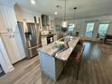 This kitchen offers a large island with a breakfast bar, stainless steel appliances, and shaker cabinets at 640 Semaht St, Charleston, SC 29412